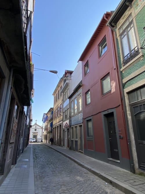 Charming cobblestone street in Porto with colorful historic buildings and church, Casa45 BnB location