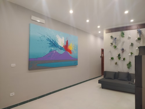 Modern family room at Royal Rooms Station Napoli with colorful abstract artwork, hanging plants, dark sofa, and recessed
