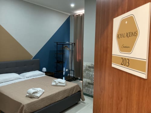 Room 203 at Royal Rooms Station Napoli, Naples - modern bedroom with blue accent wall, black bed, and city view