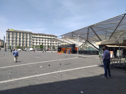 Piazza Garibaldi square in Naples, Italy with historic buildings and market stalls, location of Royal Rooms Station Napoli