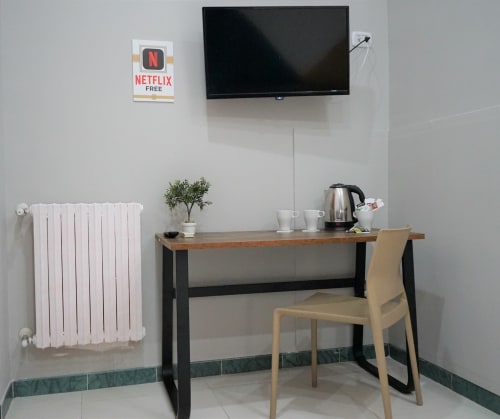 Modern Superior King Room at Royal Rooms Station Napoli with work desk, flat-screen TV, kettle, and white radiator