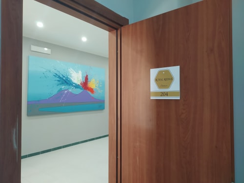 Royal Rooms Station Napoli Superior King Room entrance with modern volcano art and room number 204 sign
