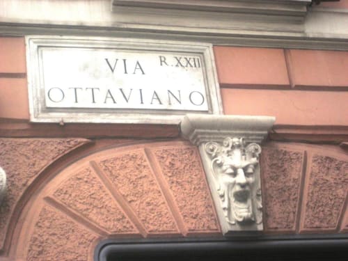 Via Ottaviano street sign on red brick building facade in Rome near Maison Vaticana Guest House