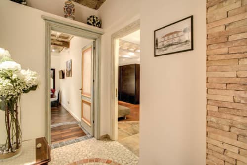 Elegante ingresso dell'appartamento Tommaso presso Orso Luxury Apartments Roma, con corridoi luminosi, mattoni a vista e