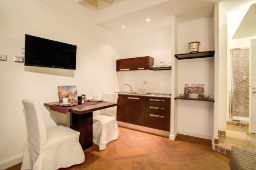 Bernini apartment at Orso Luxury Apartments in Roma features kitchenette, dining area, TV, and wooden floors