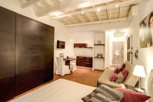 Bernini luxury apartment at Orso in Rome featuring bedroom, kitchenette, and seating area