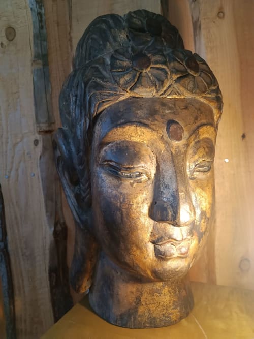 Wooden Buddha head sculpture in La Yourte de Bouddha cottage at Les Refuges Du Chalet, Jalhay