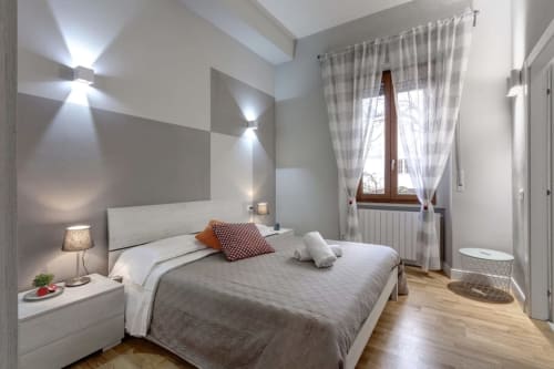 Modern bedroom at Sleep tight Florence B&B in Firenze with white furniture, gray accents, and natural light