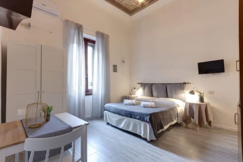 Bright bedroom at Sleep tight Florence B&B in Firenze featuring double bed, TV, modern furnishings and natural light