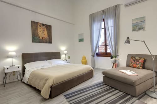 Modern bedroom at Sleep tight Florence B&B in Firenze with bed, seating area, and artwork