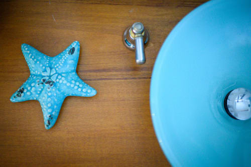 Stelle marine turchesi e accessori da bagno su superficie in legno presso l'hotel Il Podere Prato