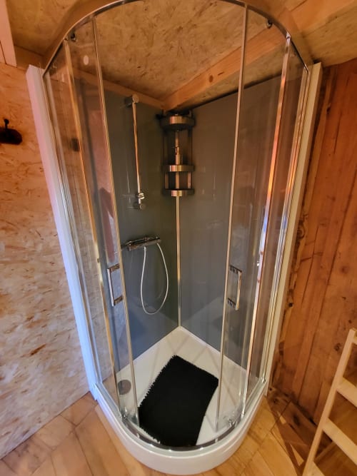Modern shower enclosure in cottage at Les Refuges Du Chalet, Jalhay with glass doors and rainfall showerhead