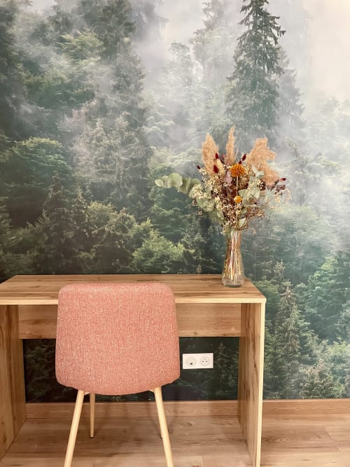 Desk and designer chair facing forest mural