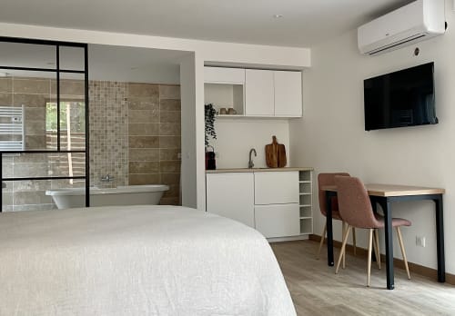 Bedroom with desk, wall-mounted TV and chair