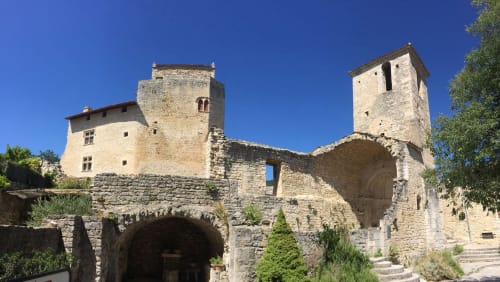 Medieval stone castle towers and arches at Le Pavillon M in Grignan, France