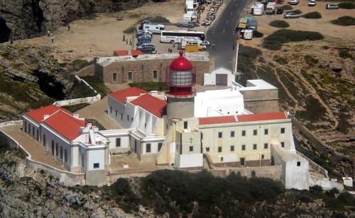 Aerial view of white and red-roofed chapel at Armação Beach Residences, Armação de Pêra, Portugal