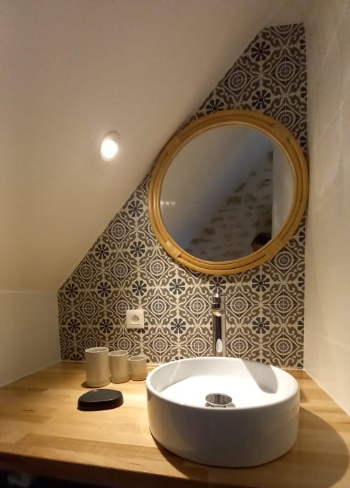 Lavabo moderne aux formes arrondies et miroir doré à l'hôtel La Maison De Fleurat à Domeyrot, France