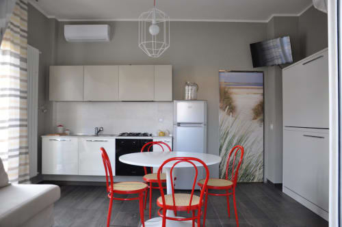 Equipped kitchen at Casa Marzi in Pesaro with table and bunk bed in the living room - near B&B Albornoz in Urbino, Marche.