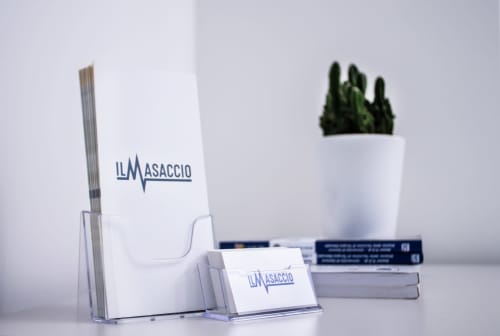 Casa Mirko Arezzo desk organizer with branding, cactus plant, and stacked books in modern B&B interior