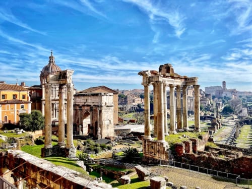 Roman Forum ruins with ancient columns and Baroque church, Rome Italy