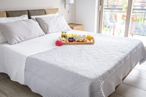Habitación doble Museo19 en Nápoles con bandeja de desayuno, ropa de cama blanca y balcón con vistas a la ciudad