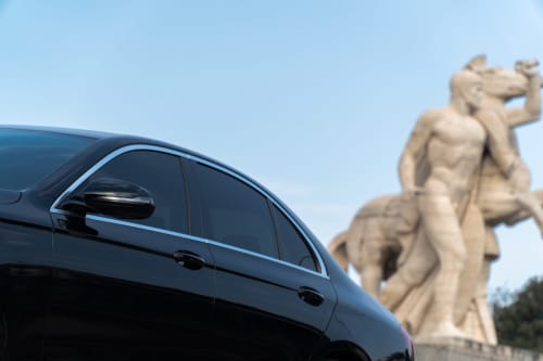Black car parked near classical statue at B&B Il Conservatorio, Naples Italy