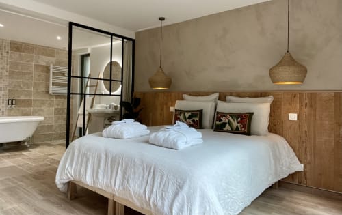 Elegant bedroom with large window and small lounge area