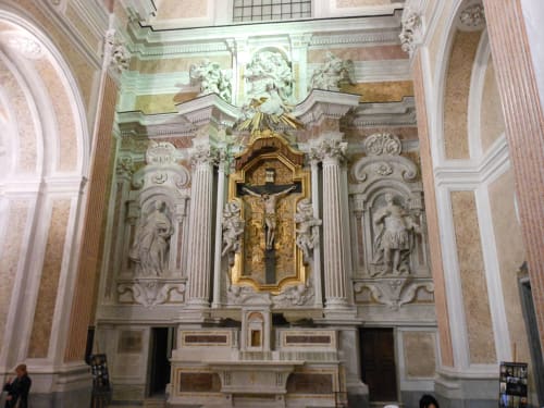 Ornate baroque chapel altar with golden crucifix in Naples historic building at Royal Rooms Station Napoli