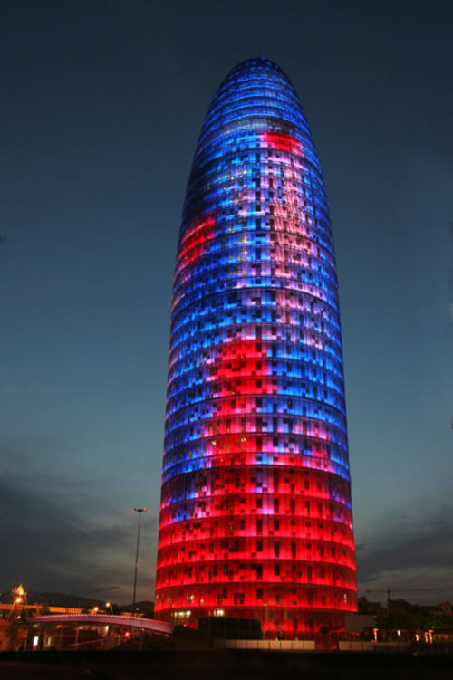 Torre Agbar illuminated in blue and red at night, Barcelona city view from Mira Barna hotel