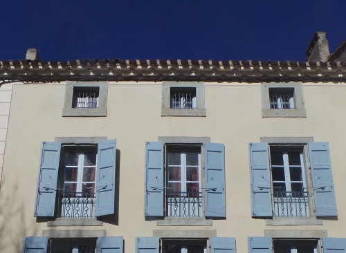 Les volets de la façade sont de couleur bleu ciel et le système de fermeture est d'origine de 1810. La Cour Carrée est une maison d'hôtes de charme située à Carcassonne dans la Bastide entre la cité médiévale et le canal du midi. Vous pouvez y dormir et diner en table d'hôtes. Le petit-déjeuner est inclus dans le tarif ainsi que l'accès internet, le linge de lit et le linge de toilette. La maison est silencieuse et propre.