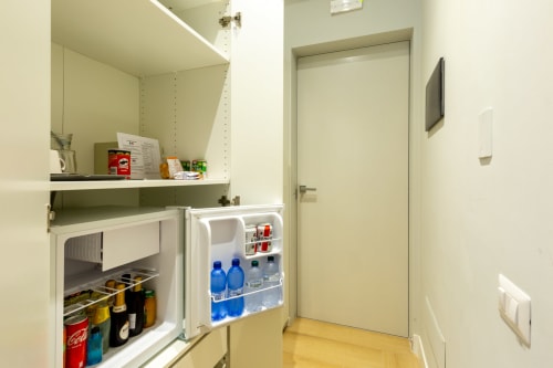 Piccola zona cucina con frigorifero, microonde e scaffalature presso Casa Lounge Istria, Cagliari
