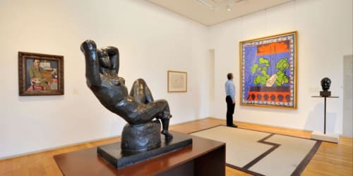 Modern art gallery space at Le Grand Duc guesthouse in Valenciennes with sculpture and colorful artwork displays