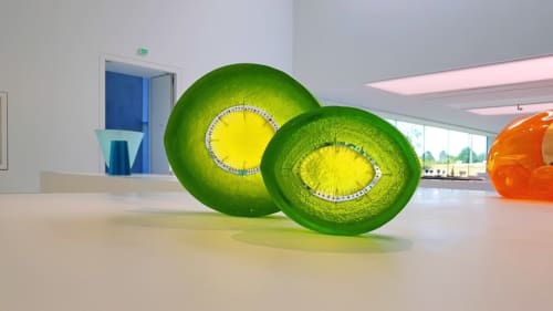 Modern art installation with green spherical sculptures featuring yellow centers in Le Grand Duc lobby, Valenciennes