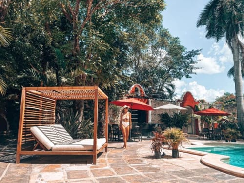 Poolside serenity at Villa Merida Boutique Hotel. The photo captures the inviting pool area, adorned with sun loungers, creating an idyllic setting for guests to unwind and soak up the sun in peaceful luxury.