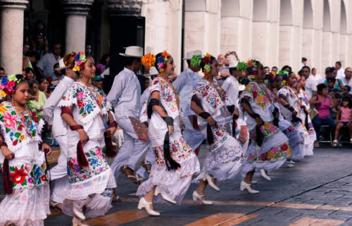 pepole dancing in traditional costumes in merida