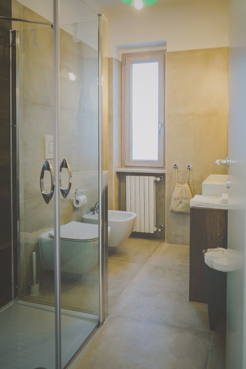 Bagno moderno della Casa Ziazì BnB a Monopoli con doccia walk-in, bidet e piastrelle gialle