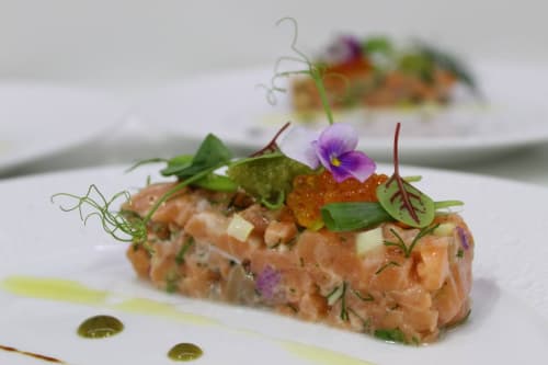 Gourmet salmon tartare with microgreens and edible flowers at Pavillon Des Millesimes SPA, Lussac