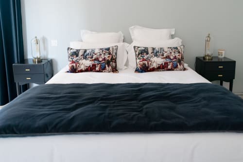 Elegant bedroom at Pavillon Des Millesimes, Lussac with dark duvet, white linens, and decorative pillows at luxury French B&B