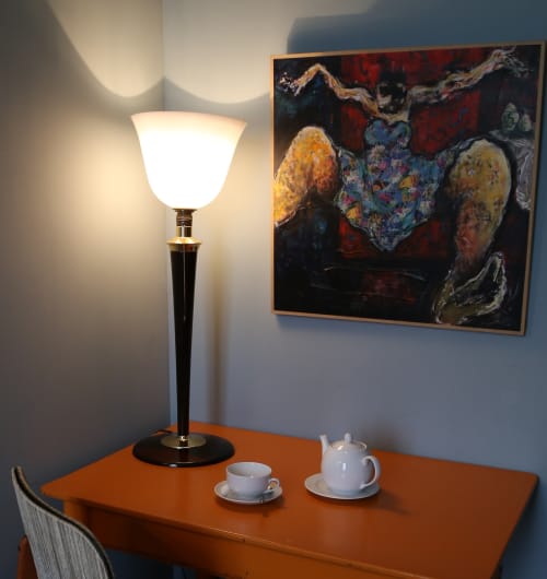 Elegant desk in Chapter 1 room at Le Grand Duc, Valenciennes, with lamp, tea set, and contemporary artwork