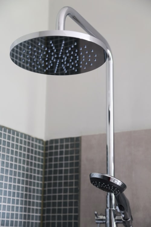 Modern overhead rainfall shower head with hand shower in Le Grand Duc bathroom, Valenciennes