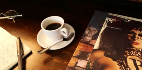 Tasse de café et soucoupe avec stylo sur un bureau de la boutique-hôtel Le Grand Duc à Valenciennes, France