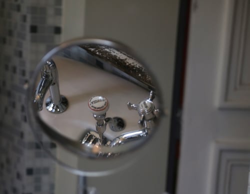 Chrome bathroom fixtures and faucet at Le Grand Duc bed and breakfast in Valenciennes