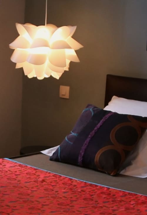 Modern pendant lamp above bed at Le Grand Duc boutique hotel in Valenciennes