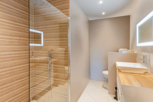 Modern bathroom at Les Maisons de Chamirey in Mercurey with walk-in shower, vanity, and heated towel rack