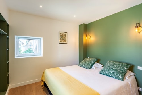 Bedroom in La Maison du Grand Four at Les Maisons de Chamirey, Mercurey with green accent wall, double bed, and modern