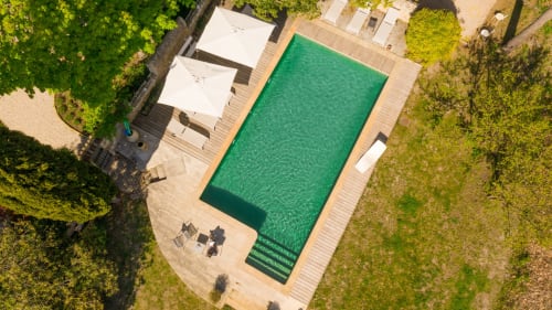 panoramic view of the pool and the wooded property