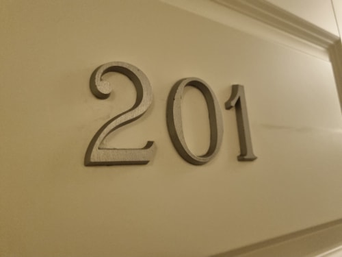 Room 201 door number plaque at B&B Il Conservatorio hotel in Naples, Italy