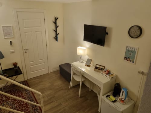 Confort Suite bedroom at B&B Il Conservatorio in Naples with desk, TV, and modern furnishings