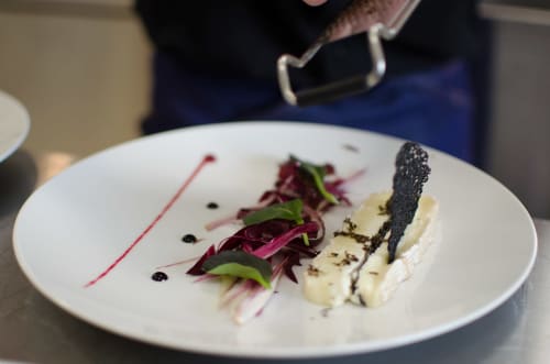 Fine dining plate at Pavillon Des Millésimes: beet salad, cheese, and microgreens on white plate