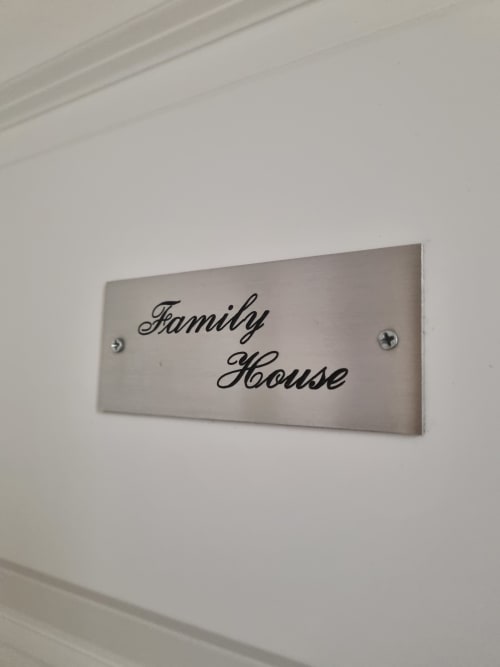 Family House sign on white wall at B&B Il Conservatorio, Naples luxury suite entrance